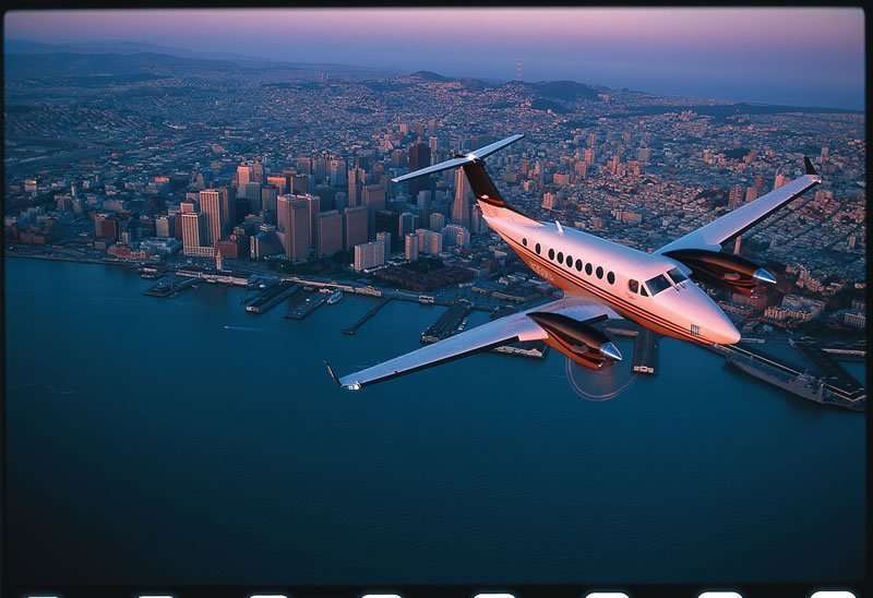 Beechcraft King Air Private Jet Over City | Stratos Jets