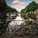 Bicycles Resting Against Bridge Rail in Amsterdam | Stratos Jet Charters, Inc.