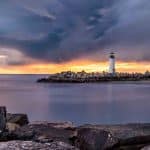 Stony Peninsula with Lighthouse During Sunset in Santa Cruz | Stratos Jet Charters, Inc.