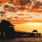 Bright Orange Sunset Over Pier in Naples, Florida | Stratos Jet Charters, Inc.