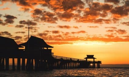 Bright Orange Sunset Over Pier in Naples, Florida | Stratos Jet Charters, Inc.