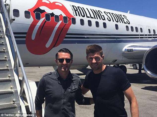 Robbie Keane (left) and Steven Gerrard pose for a photo in front of the Rolling Stones' private jet in LA -- Photo by Daily Mail