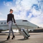 A woman walking away from a private jet.
