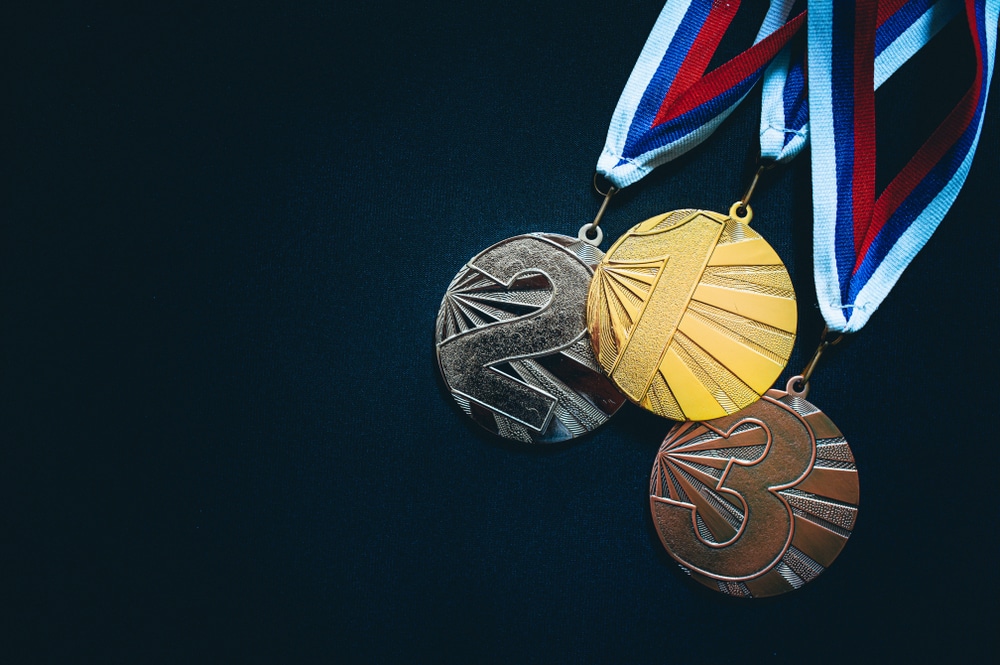 Bronze, silver and gold medals on red, white and blue lanyards.