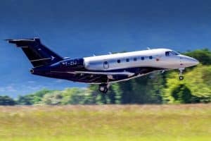Embraer Legacy 450 Taking off On Runway | Stratos Jets Charters, Inc.