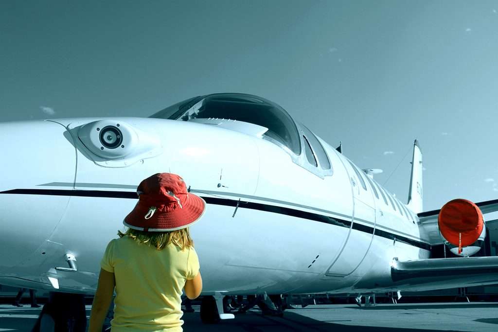 child look at on-demand private jet charter from the tarmac