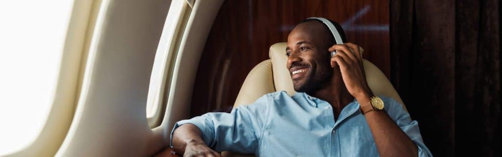 man wearing headphone enjoying private jet charter