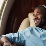 man wearing headphone enjoying private jet charter