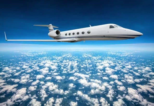 private jet high above clouds