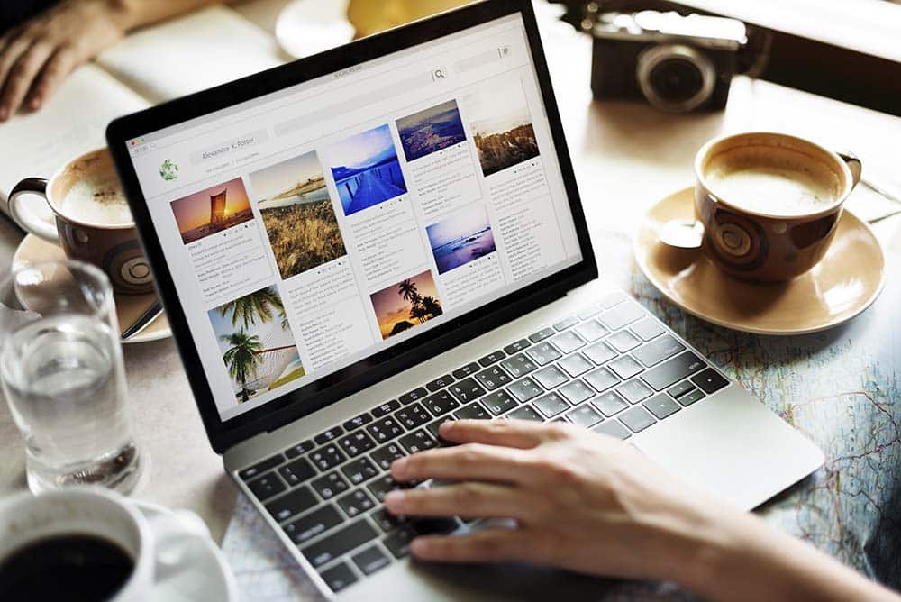 A person looking at travel destinations on their laptop