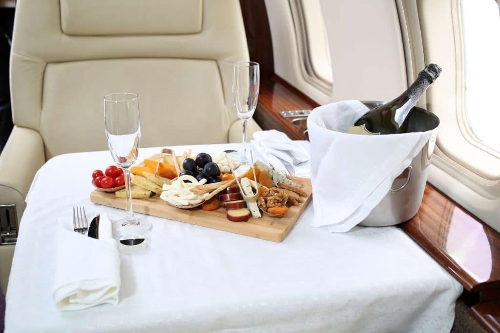 cheese platter and champagne inside private jet