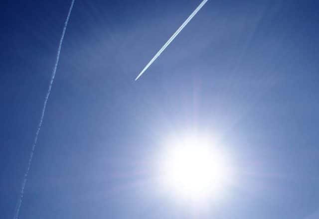 Sun with contrail