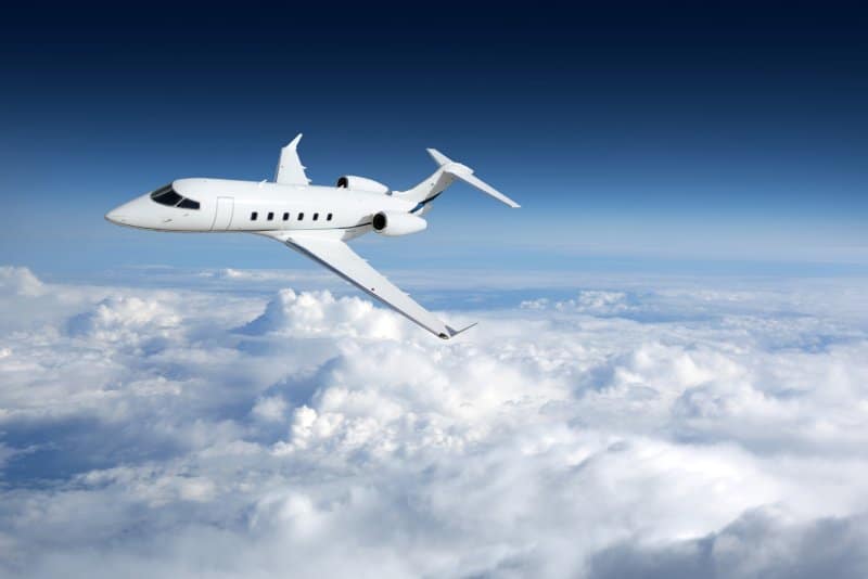 A private jet banking above the clouds.