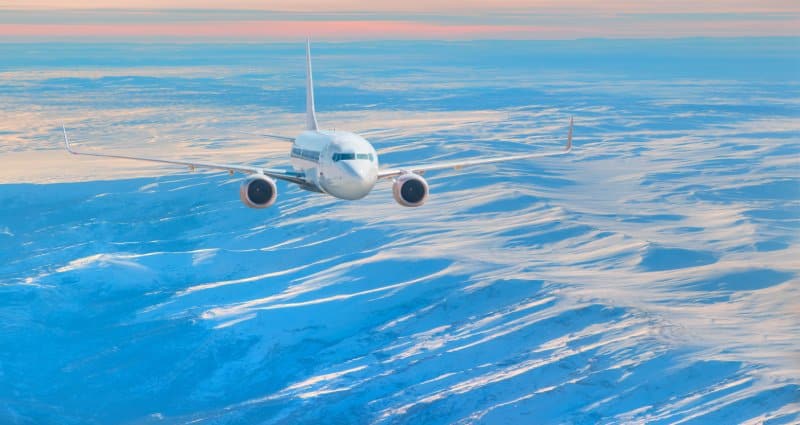 A private jet landing in a winter wonderland.