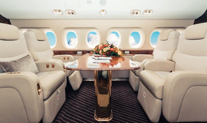 Interior of a business jet with comfortable seating.