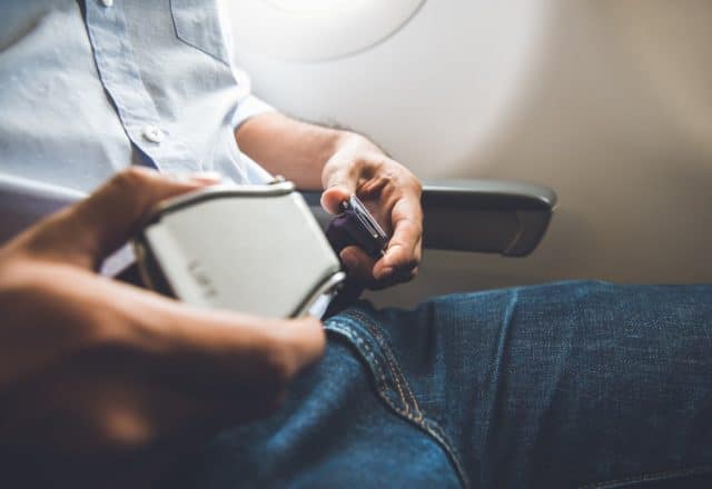 A passenger buckling his seatbelt on a private jet flight