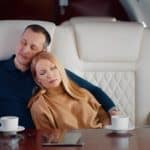 A couple takes a nap during a private charter jet flight.