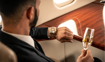 A private flier checks their watch while in the sky. Here's what you need to know about how long jet lag lasts.