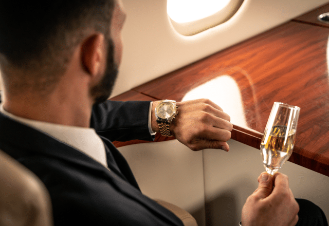 A private flier checks their watch while in the sky. Here's what you need to know about how long jet lag lasts.