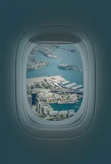 Private Jet Window Window Looking At City Skyline | Stratos Jets