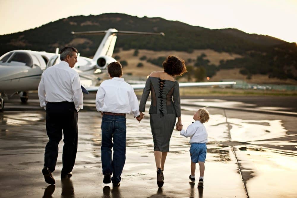 Family walking toward a private jet