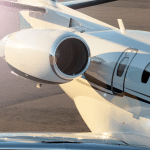 A fast private jet sits on the tarmac.