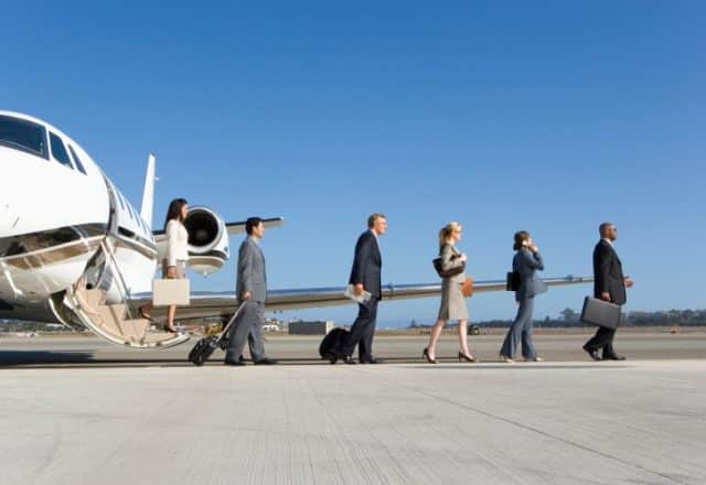 Group of business executives leaving a private jet