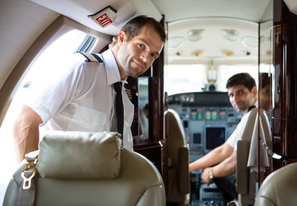 Private jet pilots smile from the cockpit