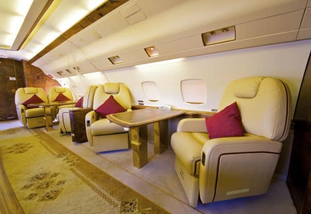 Comfortable captain's chairs in a line in a luxury private jet interior.