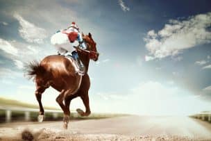 A horse and rider run into the horizon.