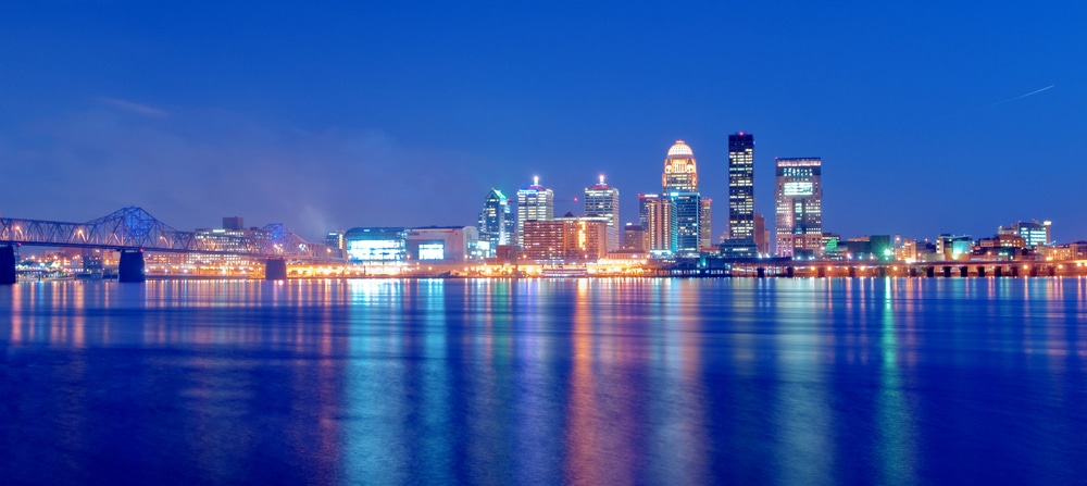 The skyline of Louisville at night, reflecting off the water