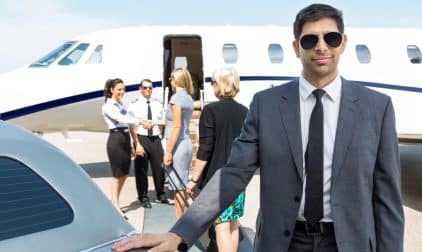 A portrait of a confident businessman in a suite getting ready to board a private jet.