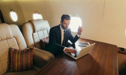 A business man flying on a private jet.