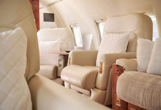 An interior view of a luxurious private jet cabin.