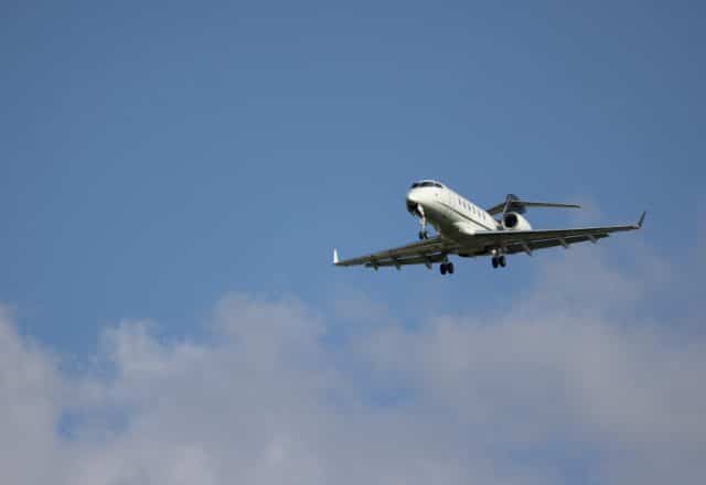 A Bombardier CL 300 descends for a landing.