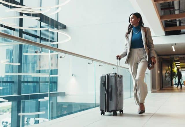 A businesswoman walking through an airport