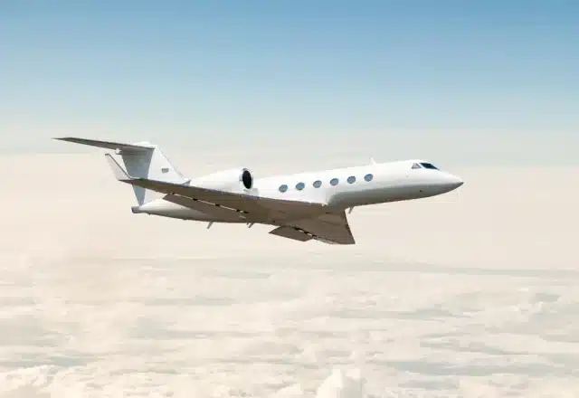 A private jet soars above the clouds.