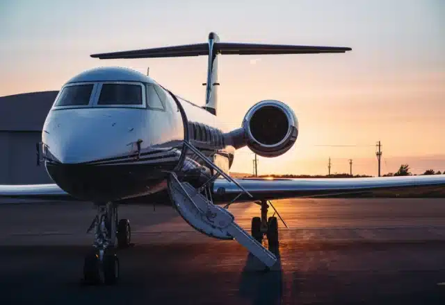 A private jet on a tarmac at sunrise
