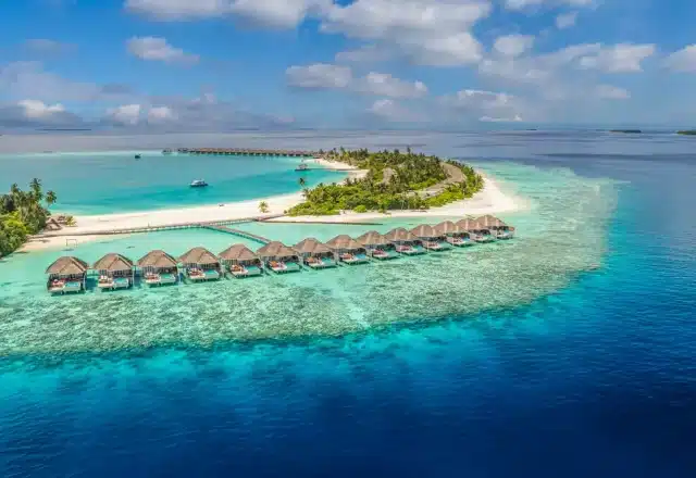 An aerial view of a Maldives resort on the ocean.
