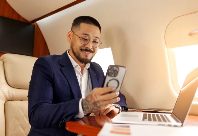 A businessman uses WiFi while on a private charter jet.