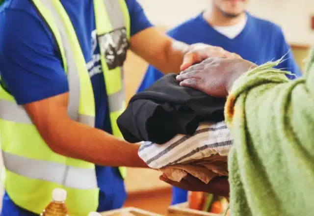 Humanitarian aid workers distribute clothing following a natural disaster