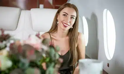 A beautiful woman sitting in a private jet.