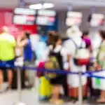 A soft focus view of a long TSA line in an airport.