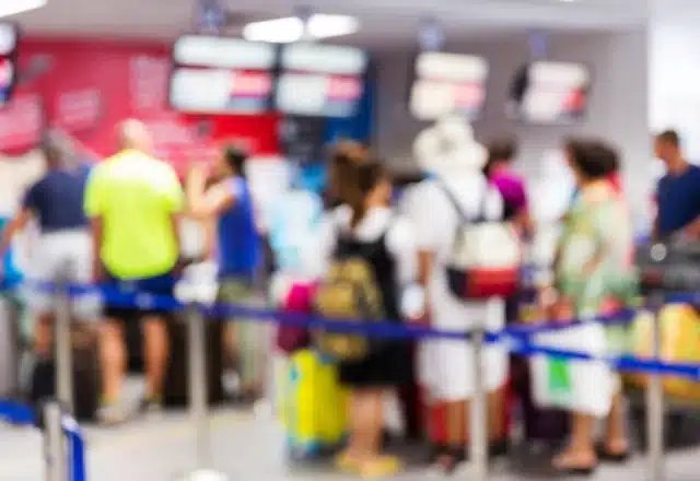 A soft focus view of a long TSA line in an airport.