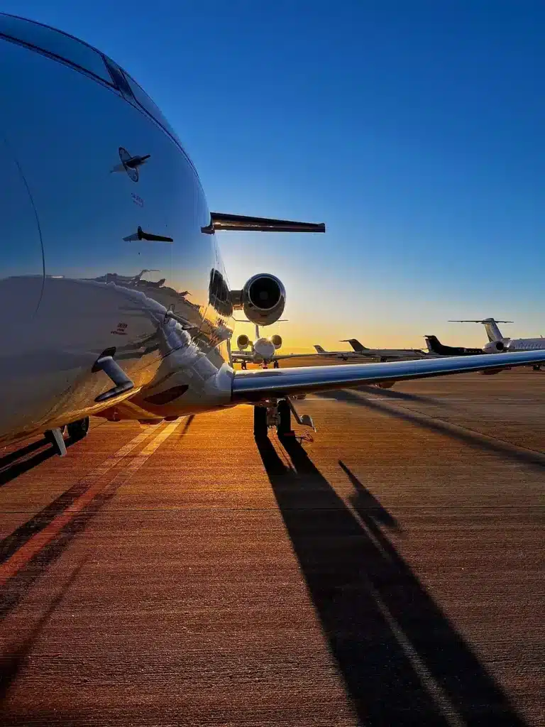 A view down the fuselage of a private jet, at sunrise.